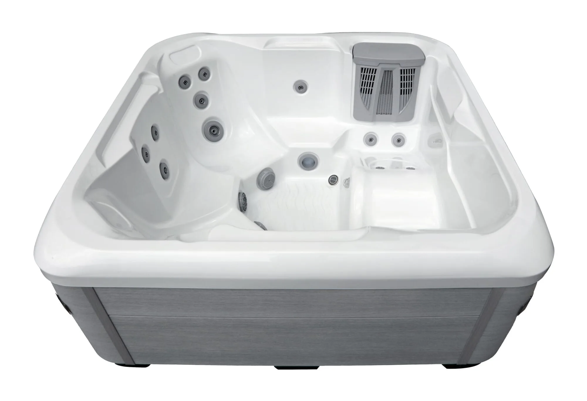 High-angle studio view of the [Model Name] holiday let hot tub, showing the durable grey composite cabinet, white acrylic interior, and a comfortable lounger seat.