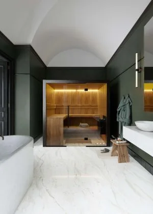 Hekla 210 large-capacity indoor traditional sauna with multi-level aspen seating and expansive panoramic glass facade, Roberts Leisure Isle of Man.