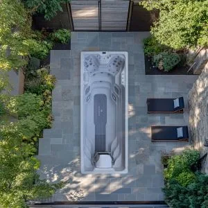 Overhead view of an AquaSolus Flow Pro swim spa installation in a luxury Isle of Man garden.