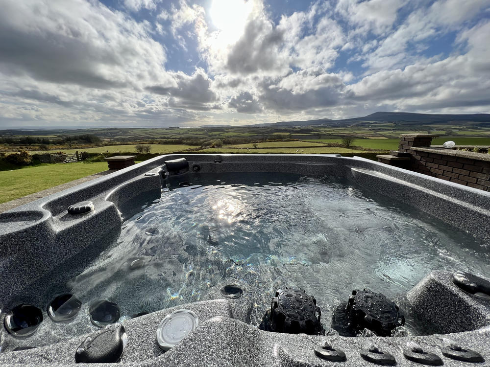 Luxury Arctic Spas hot tub with integrated lighting and hydrotherapy jets overlooking the Santon coastline, Roberts Leisure Isle of Man.