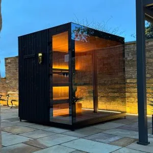 Eira 200 premium outdoor sauna featuring a full panoramic glass facade and architectural timber cladding, Roberts Leisure Isle of Man.