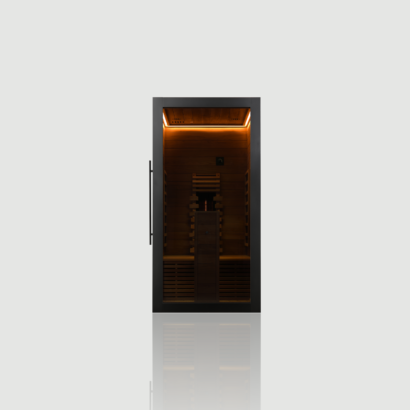 Straight-on front view of the 1-person Hekla IR 100 Infrared Sauna, featuring a modern black veneer exterior, 8mm grey safety glass door, and a brightly illuminated wood interior.