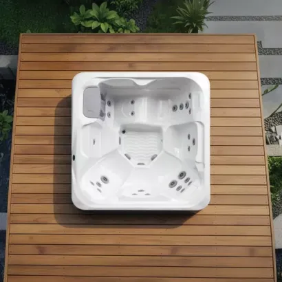 Overhead view of the Vacation Cypress holiday let hot tub installed flush in a wooden deck, showing the spacious seating layout and hydrotherapy jets.
