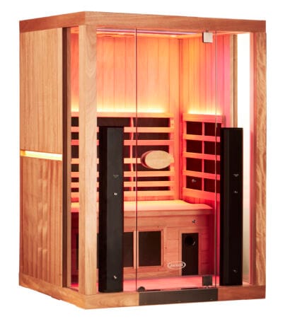 A left three-quarter angled view of a 2-person Jacuzzi infrared sauna, showcasing the vertical cedar siding with an embedded light strip and the glowing interior through the front glass facade.