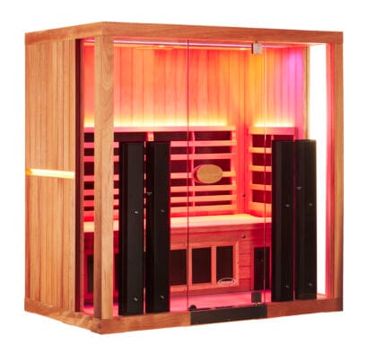 A three-quarter angled view of a spacious 3-person Jacuzzi infrared sauna, showcasing the side cedar wood paneling with an integrated light strip and a warmly lit interior through a glass facade.
