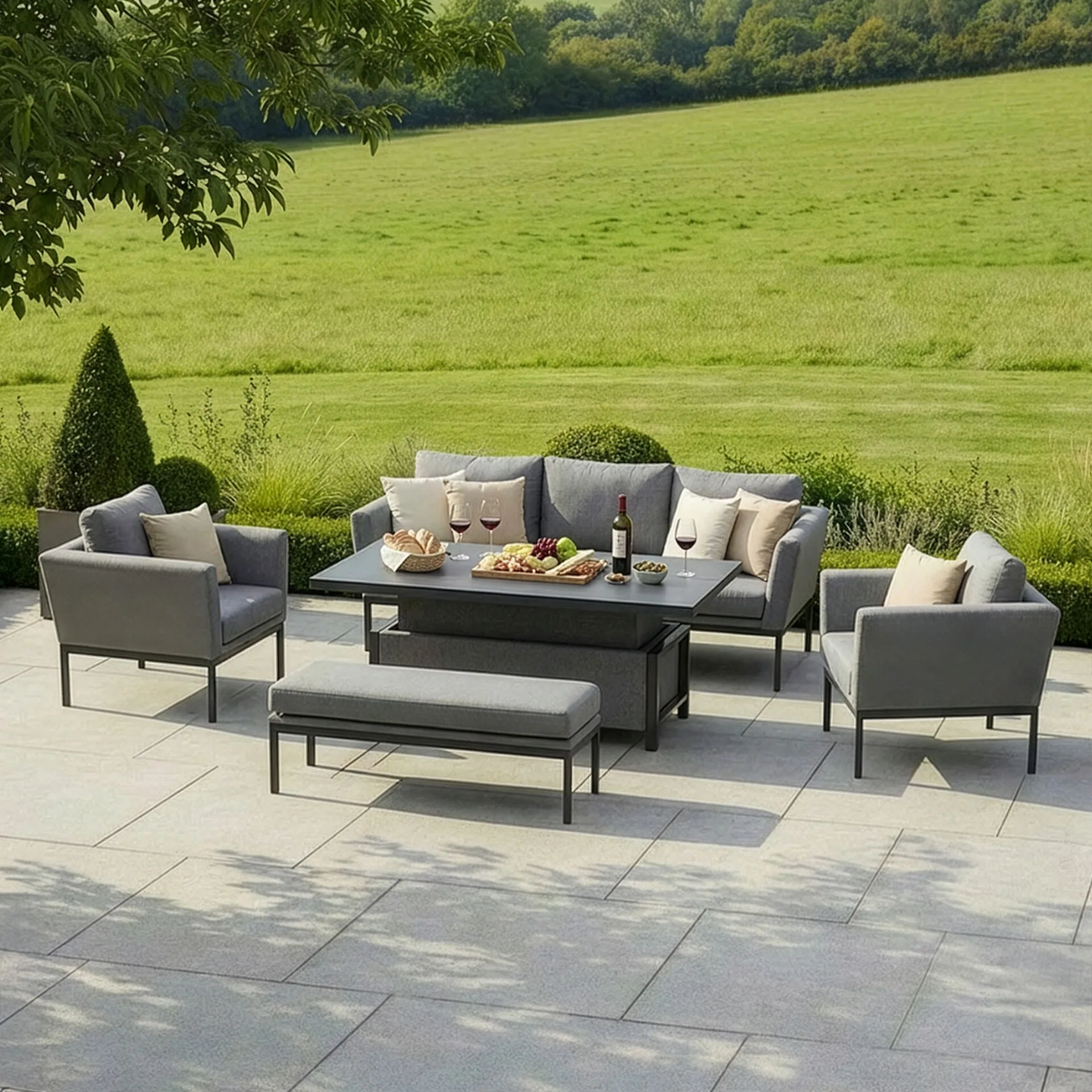 The Pulse 3 Seat Sofa Set in zinc grey fabric with the adjustable table raised for outdoor dining, supplied by Roberts Leisure in the Isle of Man.