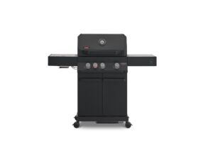 A direct front view of a matte black Primeliner G3 gas barbecue grill featuring a closed lid with an integrated temperature gauge, four control knobs, dual side shelves, and a two-door storage cabinet on wheels.