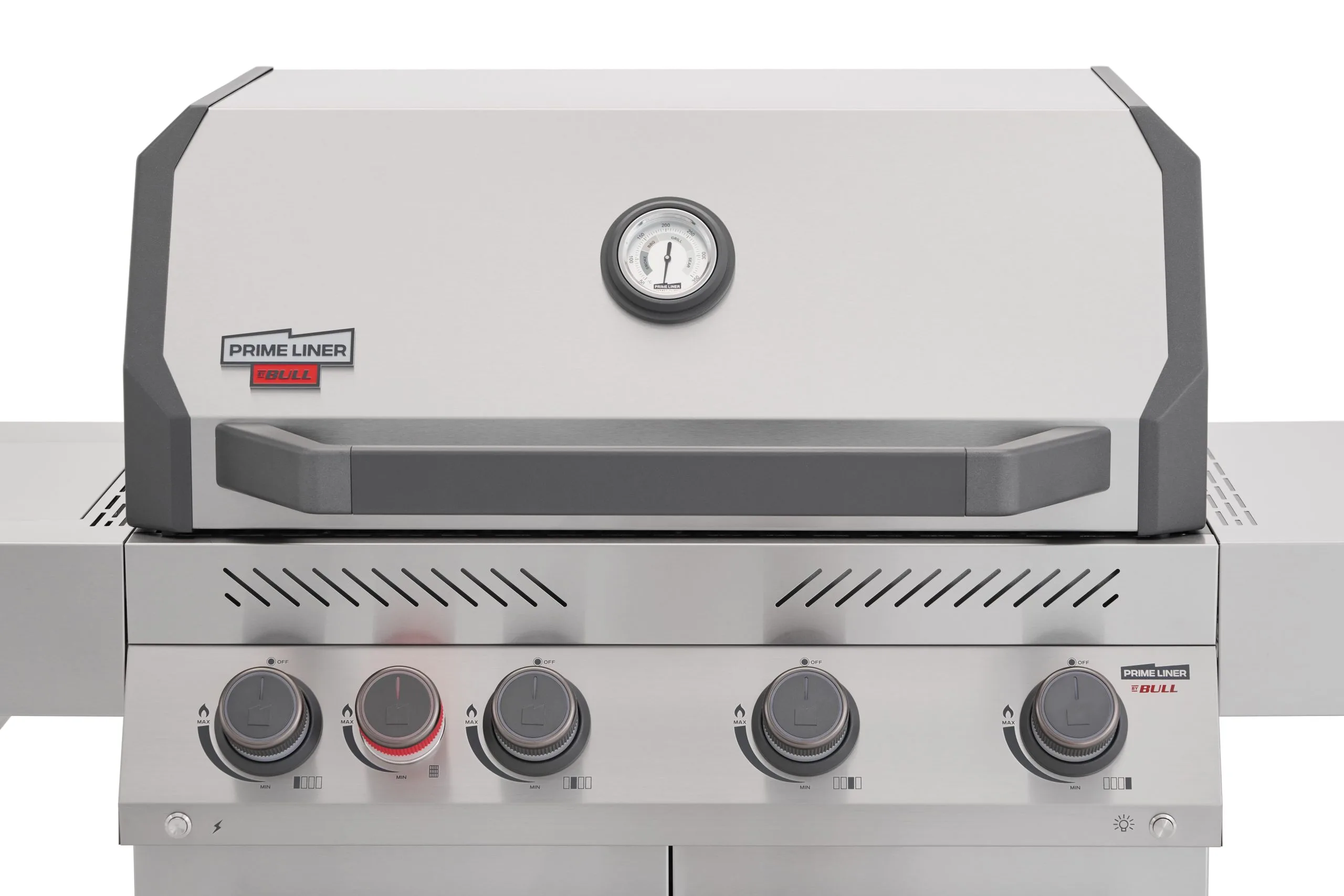 A detailed close-up view of the Primeliner S4 gas grill control panel and hood, highlighting the five grey control dials, integrated thermometer, and brand logo.