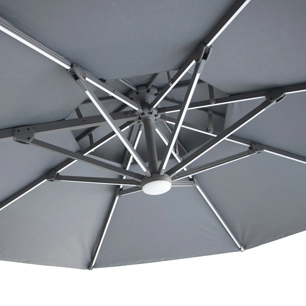 Close-up of the underside of the Apollo Solar LED 3m Round Rotating Cantilever Parasol in Charcoal Grey, showcasing the central warm white LED light hub and illuminated canopy ribs.