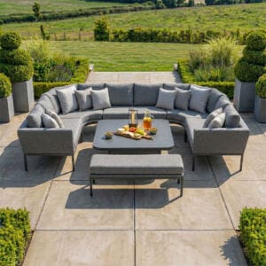 Top-down perspective of the Maze - Outdoor Fabric Pulse U Shape Corner Dining Set with Rising Table - Zinc Grey on a modern stone patio at Roberts Leisure, Isle of Man.