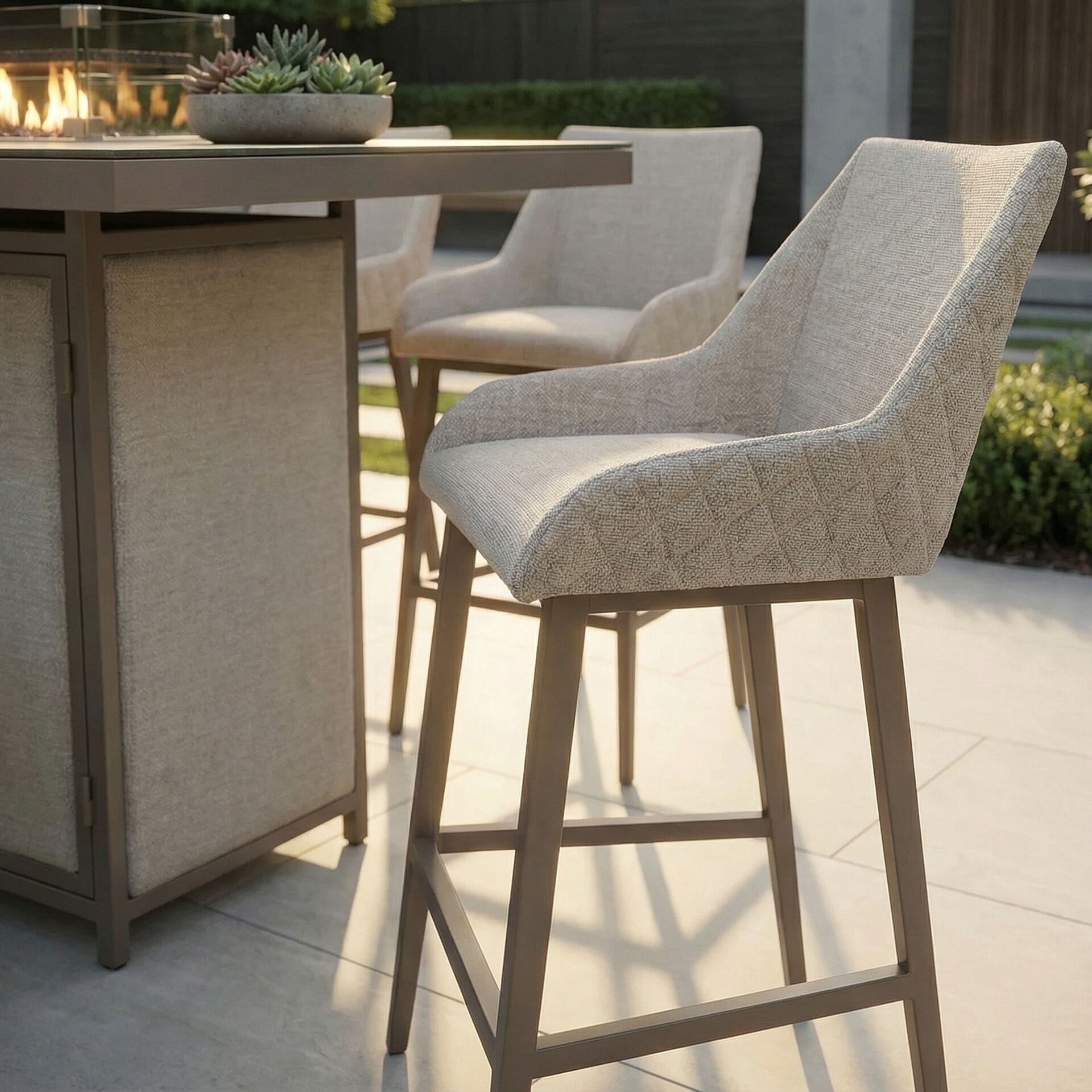 Close-up of a quilted high-rise bar stool from the Maze - Outdoor Fabric Regal 8 Seat Rectangular Bar Set Latte with café frame, available at Roberts Leisure, Isle of Man.