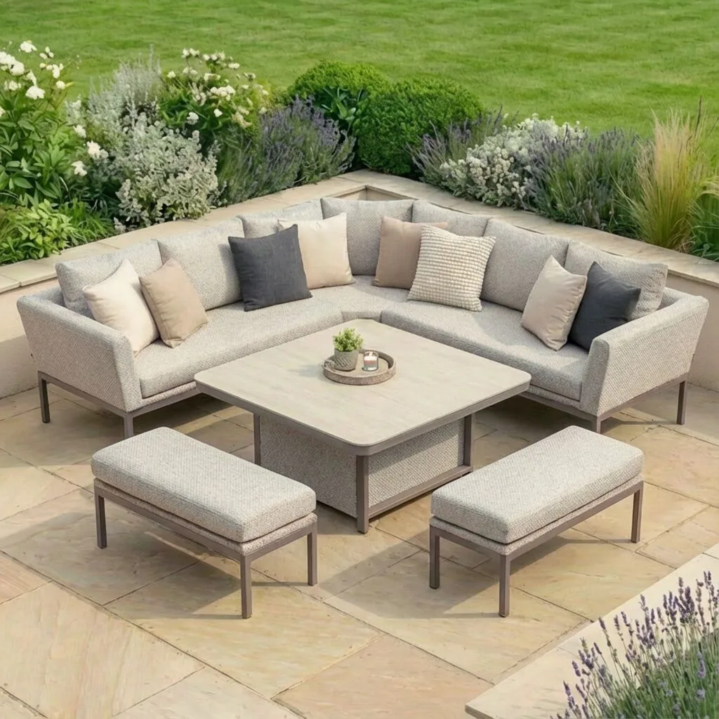 Aerial view of the Maze - Outdoor Fabric Pulse Deluxe Square Corner Dining Set with Rising Table - Latte with cafe frame, featuring a curved L-shaped sofa and two benches on a stone patio at Roberts Leisure, Isle of Man.