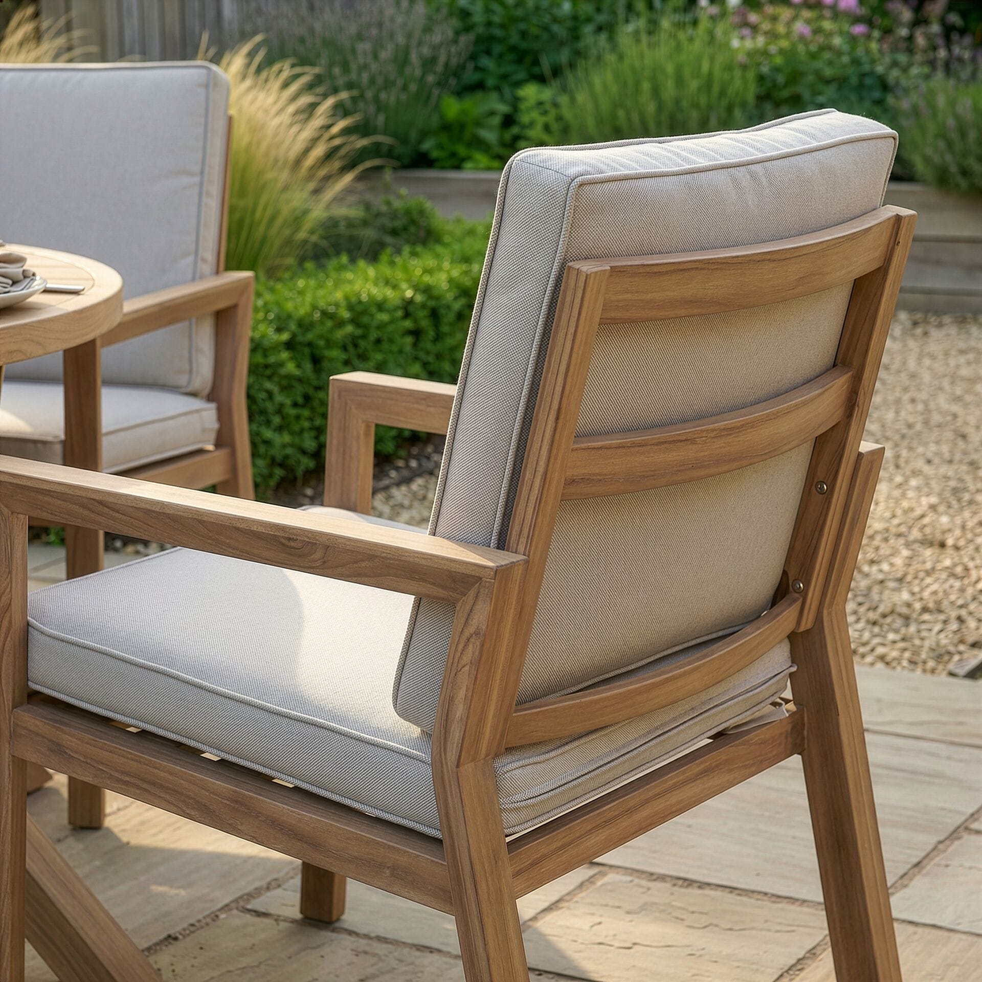 Close-up of the wood-effect aluminium frame and deep-filled weather-resistant cushions on a chair from the Maze - New York 6 Seat Round Aluminium Dining Set, available at Roberts Leisure, Isle of Man.