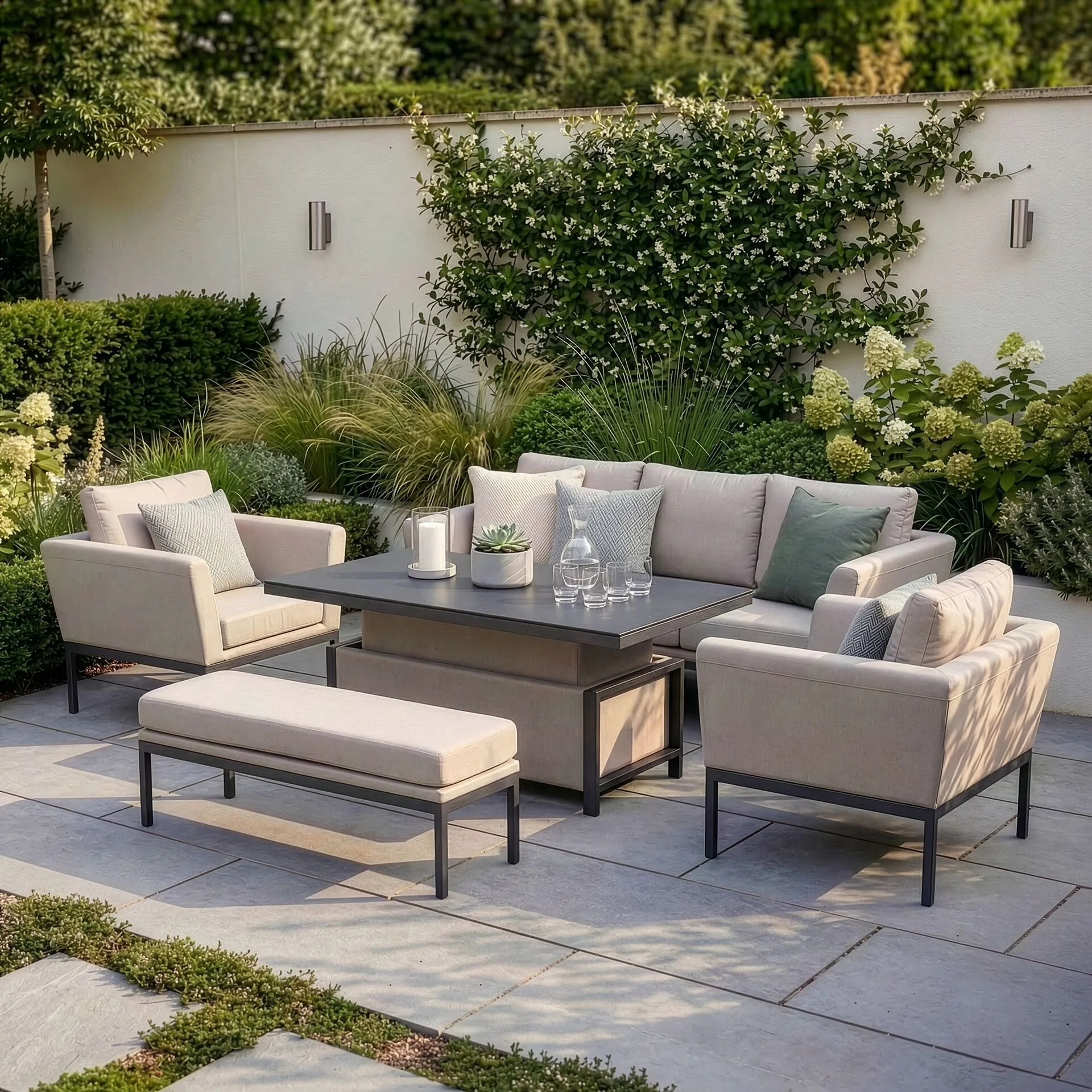 Elevated daytime view of the Maze Pulse 3 Seat Sofa Set arranged for lounging on a paved patio in a lush, landscaped garden.