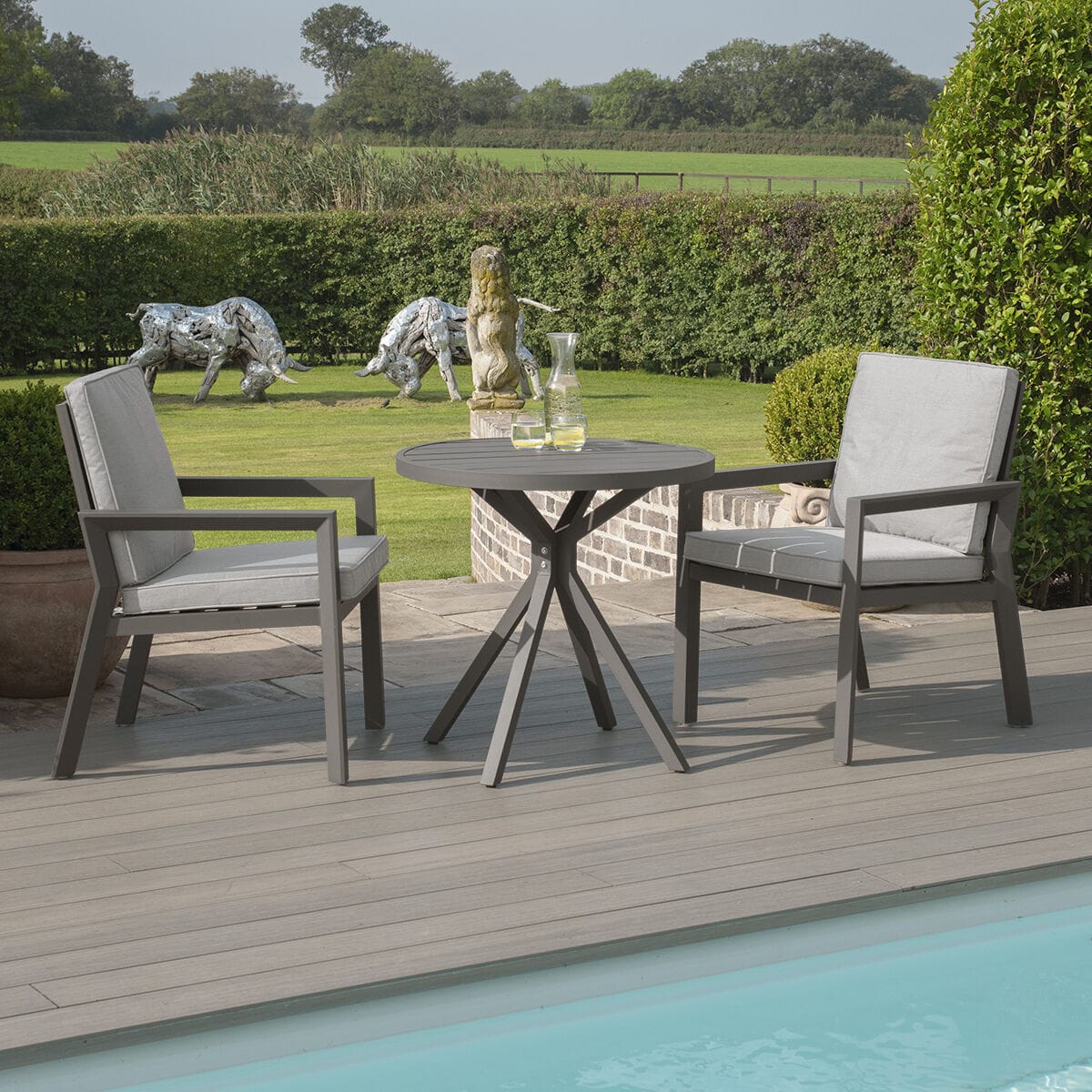 Close-up of the stylish slatted aluminium table belonging to the Maze - New York 3 Piece Aluminium Bistro Set - Dove Grey from Roberts Leisure, Isle of Man.