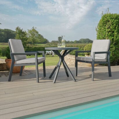 Front perspective of the modern Maze - New York 3 Piece Aluminium Bistro Set - Dove Grey with matching grey frames and cushions at Roberts Leisure, Isle of Man.