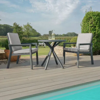 Front perspective of the modern Maze - New York 3 Piece Aluminium Bistro Set - Dove Grey with matching grey frames and cushions at Roberts Leisure, Isle of Man.